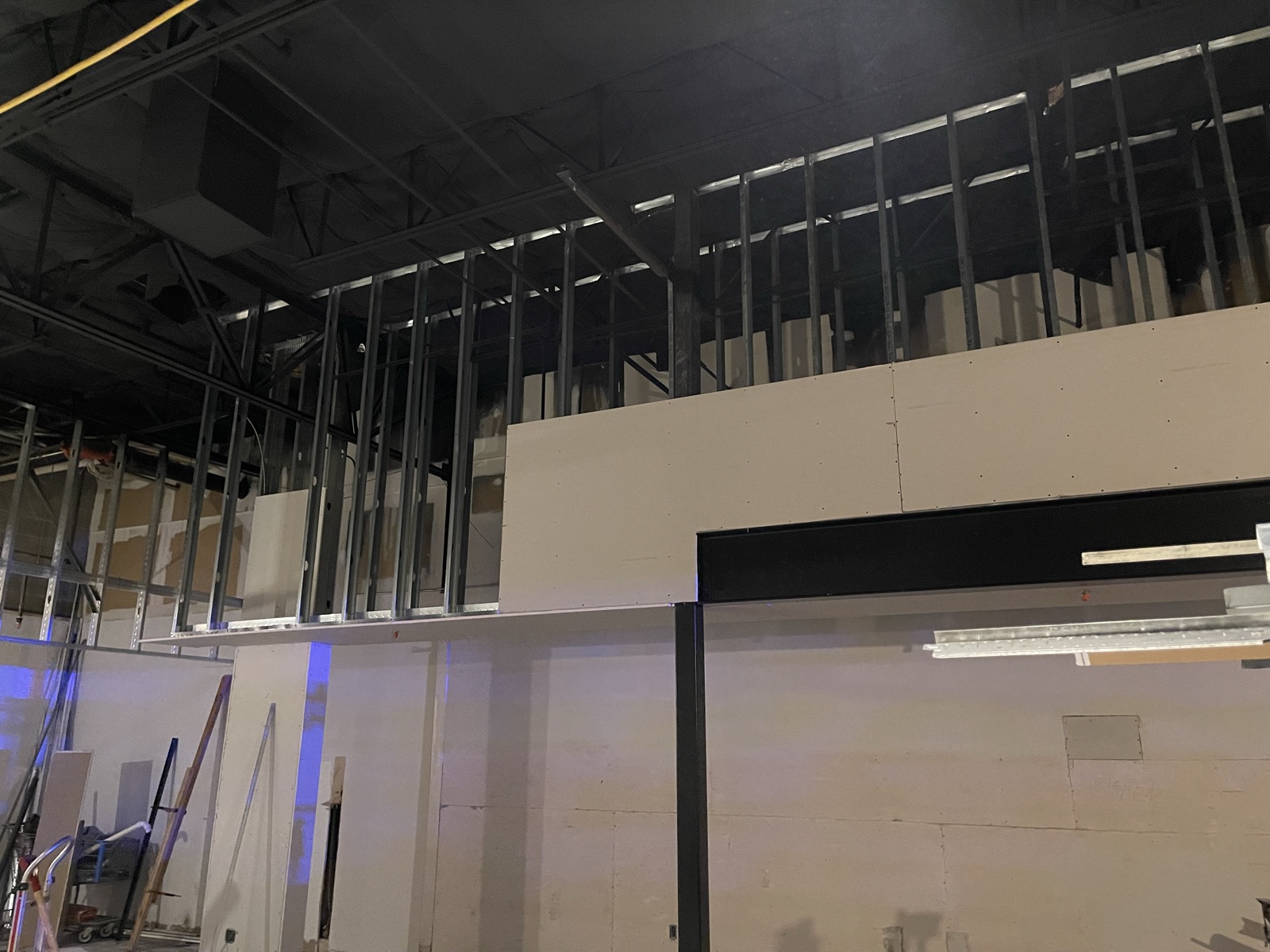 Drywall hung over the metal stud walls